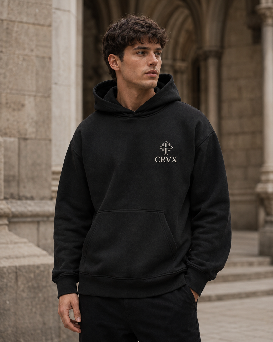 Bone CRVX Saint George hoodie worn in a stone street